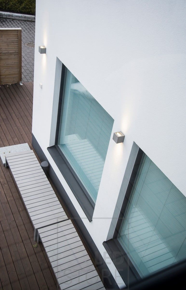 CUBIC OUT 2 is a wall lamp for outdoor use, providing a warm and atmospheric light.